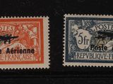 three different postage stamps on a black surface with a red and blue stamp