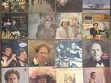 many different album covers on the floor of this room