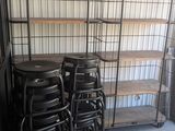 many stools and shelves in a storage room