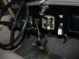 steering wheel and dashboard of an old car with a clock on it