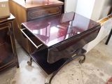 a table with a glass top and a drawer with a drawer underneath it