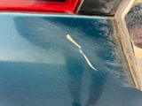 a sticker on the side of a car that has been scratched