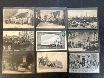 several old black and white photographs of people and vehicles on a table