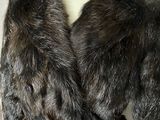 a fur coat on a mannequin with a belt around it