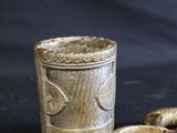 a gold cup and a silver cup on a black background