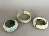 three pieces of pottery sitting on top of a table next to each other