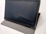 a tablet computer sitting on top of a white table