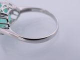 a close up of a ring with a turquoise stone in it