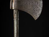 a close up of an old axe on a black background