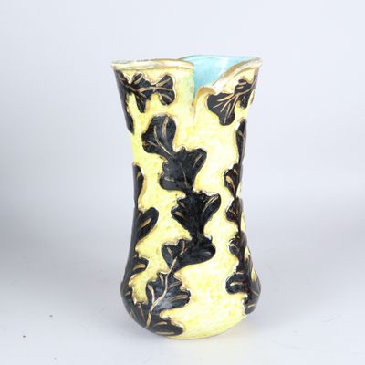 un vase jaune orné de motifs noirs et blancs