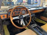 a steering wheel and dashboard of a car in a museum