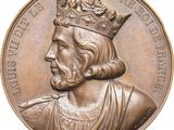 un gros plan sur une médaille de bronze représentant un homme coiffé d'une couronne