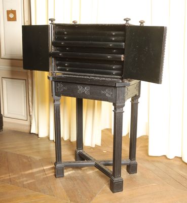 an old black table that has a closed door on it