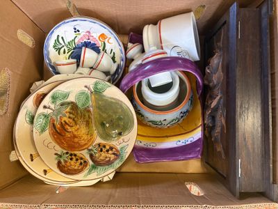 a cardboard box with a bunch of plates and cups in it