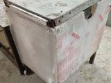 a white chest sitting on a cart in a warehouse