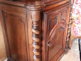 a wooden cabinet with a mirror on top of it