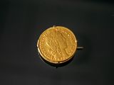 an image of a gold coin sitting on top of a black surface
