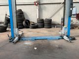 a garage with a lot of tires on the floor