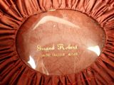a picture of a red ribbon with a gold label on it