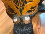a vase that has a dragon on it on the floor