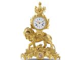 une horloge en or surmontée d'un lion