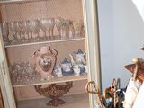 a cabinet that has a bunch of glasses in it