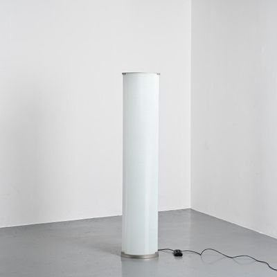 an image of a white lamp sitting on top of a floor next to a white wall