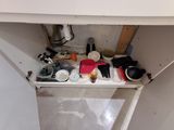 a sink that has a lot of clutter on it