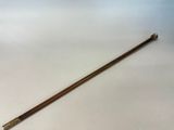 a close up of a wooden stick on a white surface