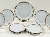 a large group of plates and bowls on a table