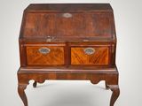 an old wooden bureau with two drawers on a stand