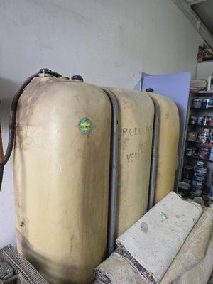 three large tanks sitting next to each other in a room