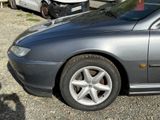 a silver car parked in a parking lot with other cars in the background