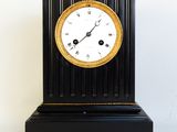 a black and gold clock sitting on top of a table