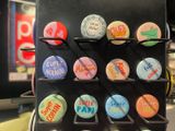 a display of buttons on a black rack in a store
