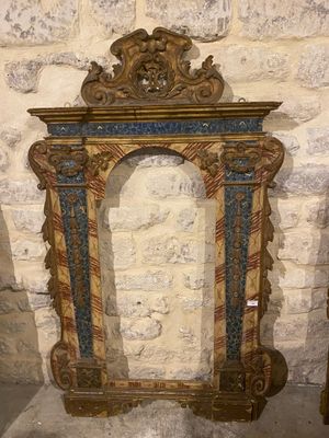 a picture of a mirror in a room with a stone wall