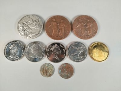 several different coins are arranged in a circle on a white surface