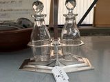 three glass bottles on a table with a price tag on it