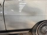 a white car with a black stripe parked in a garage