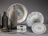 many different types of vases and plates on the table