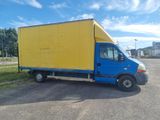 a blue and yellow truck parked in a parking lot