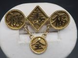 a close up of a gold plated bracelet with four charms on it