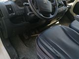 a car with a steering wheel and a bag in the passenger seat