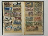 an open book with stamps on it on a table