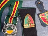 a lot of medals and badges on display on a table