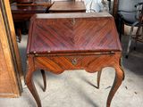 a small table with a drawer on it in a room