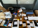 many electronic devices on a table with boxes on it