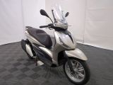 a motor scooter that is parked in a room