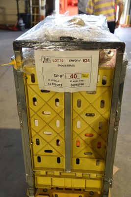 a box with a sign on top of it in a warehouse