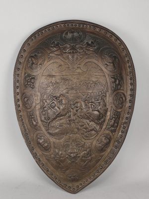 an old metal shield with a design on it
